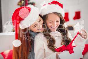 Composite image of festive mother and daughter on the couch with
