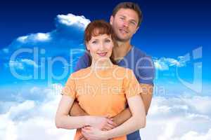 Composite image of happy couple looking at camera