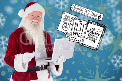 Composite image of santa pays with credit card on a laptop