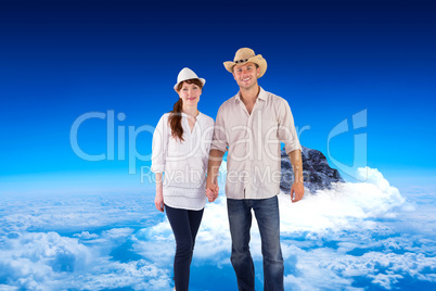 Composite image of smiling couple both wearing hats