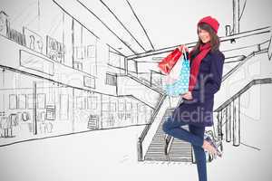 Composite image of happy brunette in winter clothes holding shop