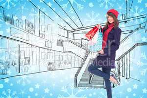 Composite image of happy brunette in winter clothes holding shop