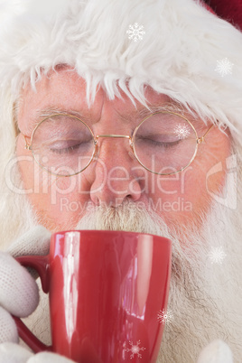 Composite image of santa drinks from a red cup