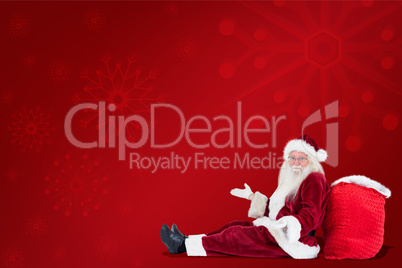 Composite image of santa sits leaned on his bag and has no clue