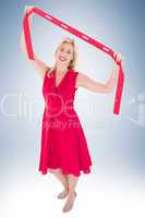 Stylish blonde in red dress holding scarf