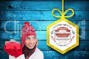 Composite image of happy brown hair holding red gift