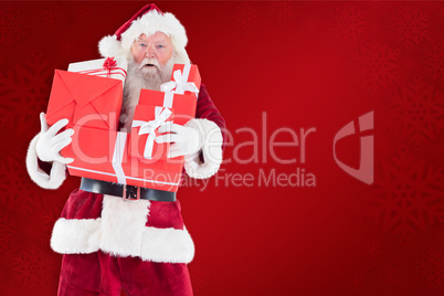 Composite image of santa carries a few presents