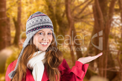 Composite image of pretty redhead in warm clothing