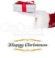 Composite image of santa claus showing gift with red ribbon