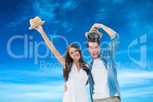 Composite image of happy hipster couple smiling at camera and ch
