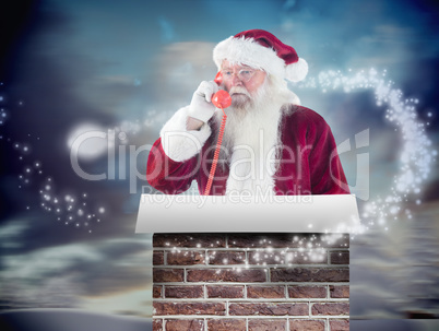 Composite image of santa on his red phone