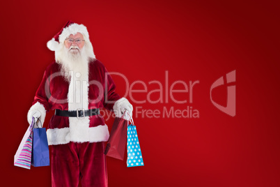 Composite image of santa carries some christmas bags