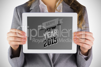 Composite image of businesswoman showing a tablet pc