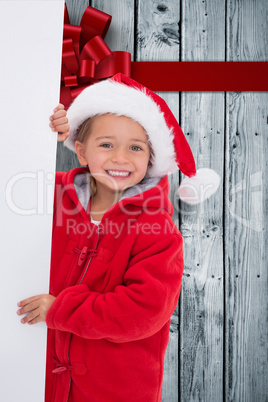 Composite image of festive little girl holding poster