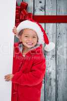 Composite image of festive little girl holding poster
