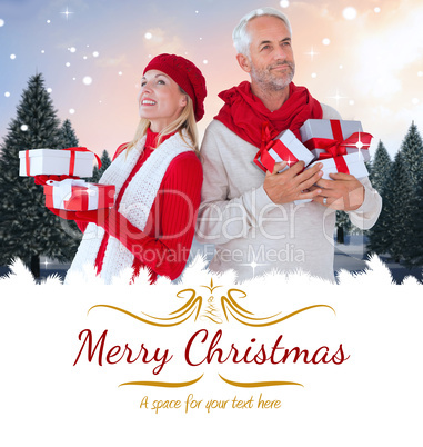 Composite image of happy festive couple with gifts