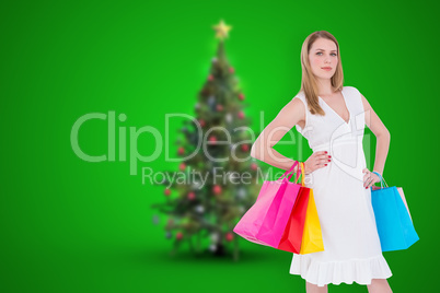 Composite image of happy blonde holding shopping bags in white d