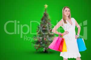Composite image of happy blonde holding shopping bags in white d