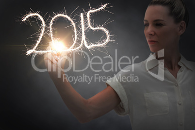 Composite image of businesswoman touching spark
