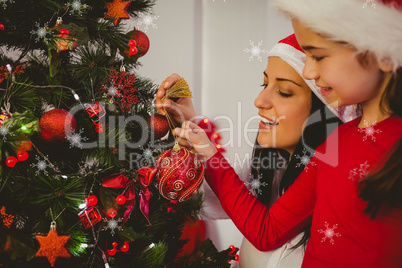 Composite image of mother and daughter hanging christmas decorat