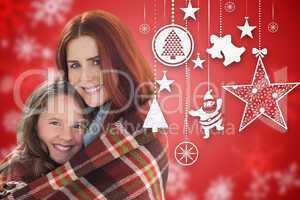 Composite image of mother and daughter under blanket