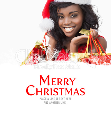 Composite image of festive woman standing looking while holding