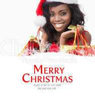 Composite image of festive woman standing looking while holding