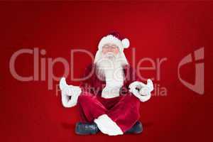 Composite image of santa claus sits and meditates