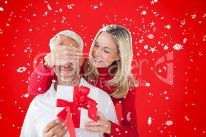 Composite image of loving couple with gift Composite image of loving couple with gift