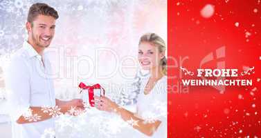 Composite image of  young couple with gift