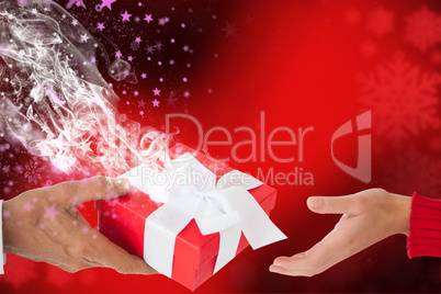 Composite image of couple holding gift