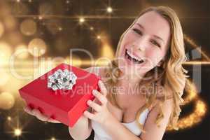 Composite image of portrait of a happy woman receiving a present