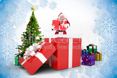 Composite image of santa standing in large gift