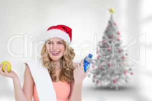 Composite image of festive fit blonde smiling at camera