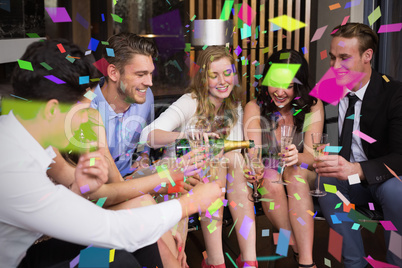 Composite image of stylish friends having a drink together