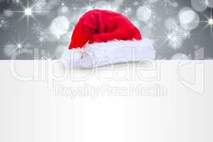 Composite image of santa hat on poster