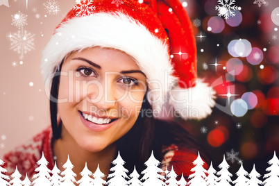 Composite image of festive brunette smiling at camera