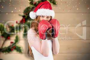 Composite image of festive redhead with boxing gloves