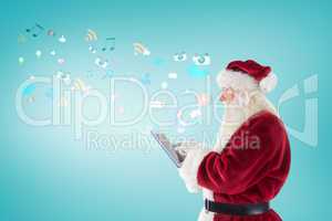 Composite image of santa uses a tablet pc