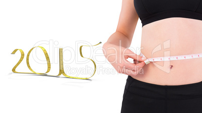 Composite image of fit woman measuring her waist