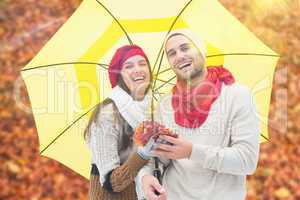 Composite image of autumn couple holding umbrella