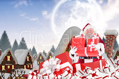 Composite image of santa standing in large gift