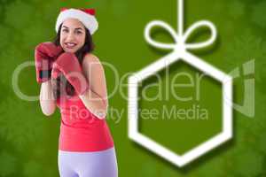 Composite image of festive brunette in boxing gloves