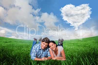 Composite image of young couple lying on floor smiling