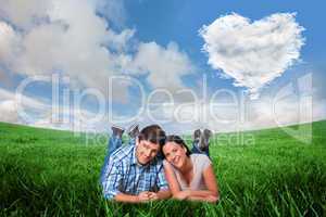 Composite image of young couple lying on floor smiling
