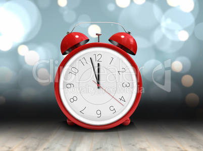 Composite image of alarm clock counting down to twelve