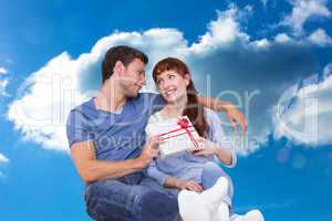 Composite image of couple sitting on floor together