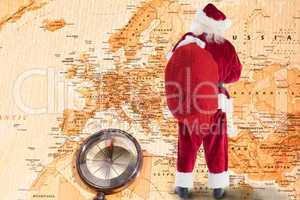 Composite image of santa is holding his bag in one hand