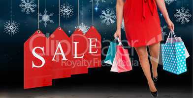 Composite image of woman standing with shopping bags