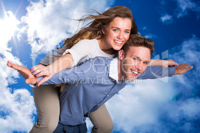 Composite image of smiling young man carrying woman